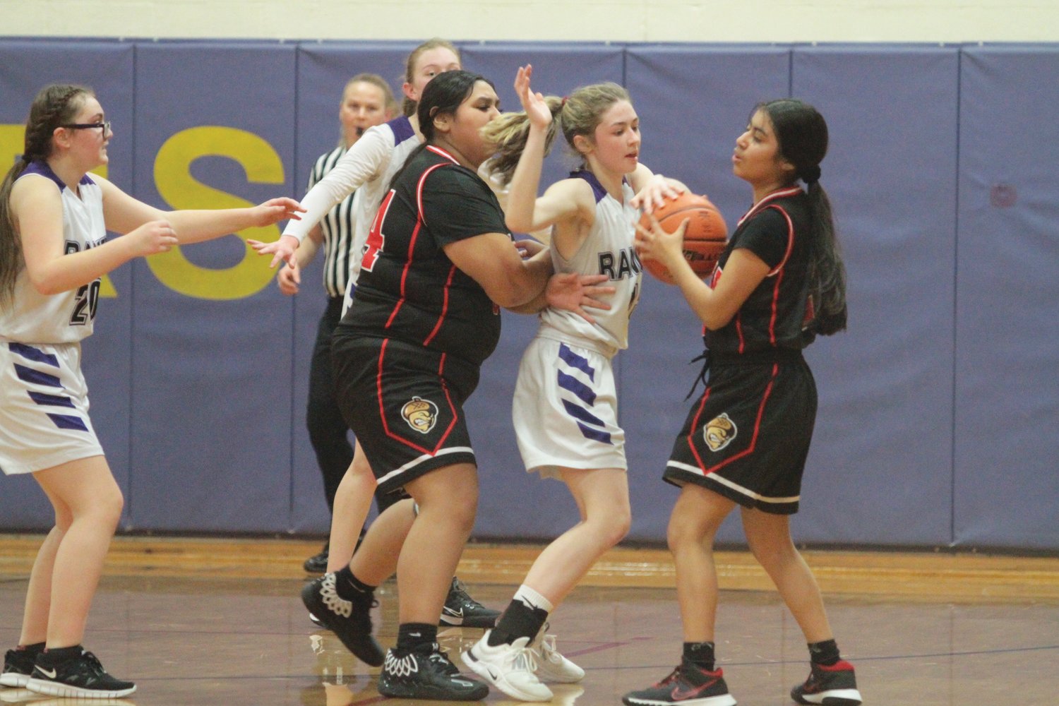Brianne Evans tries to push away a defending Savannah McBride during the first half of last week’s game. Evans was called for an offensive foul.